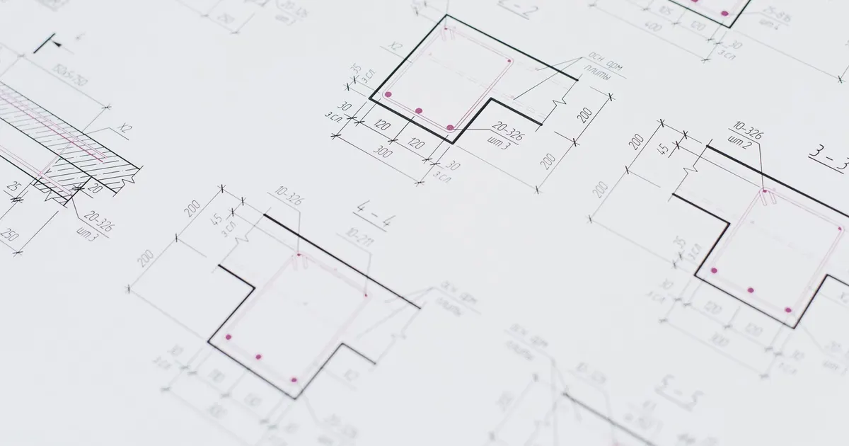 Close-up of dimensioned technical drawings with section views on white paper